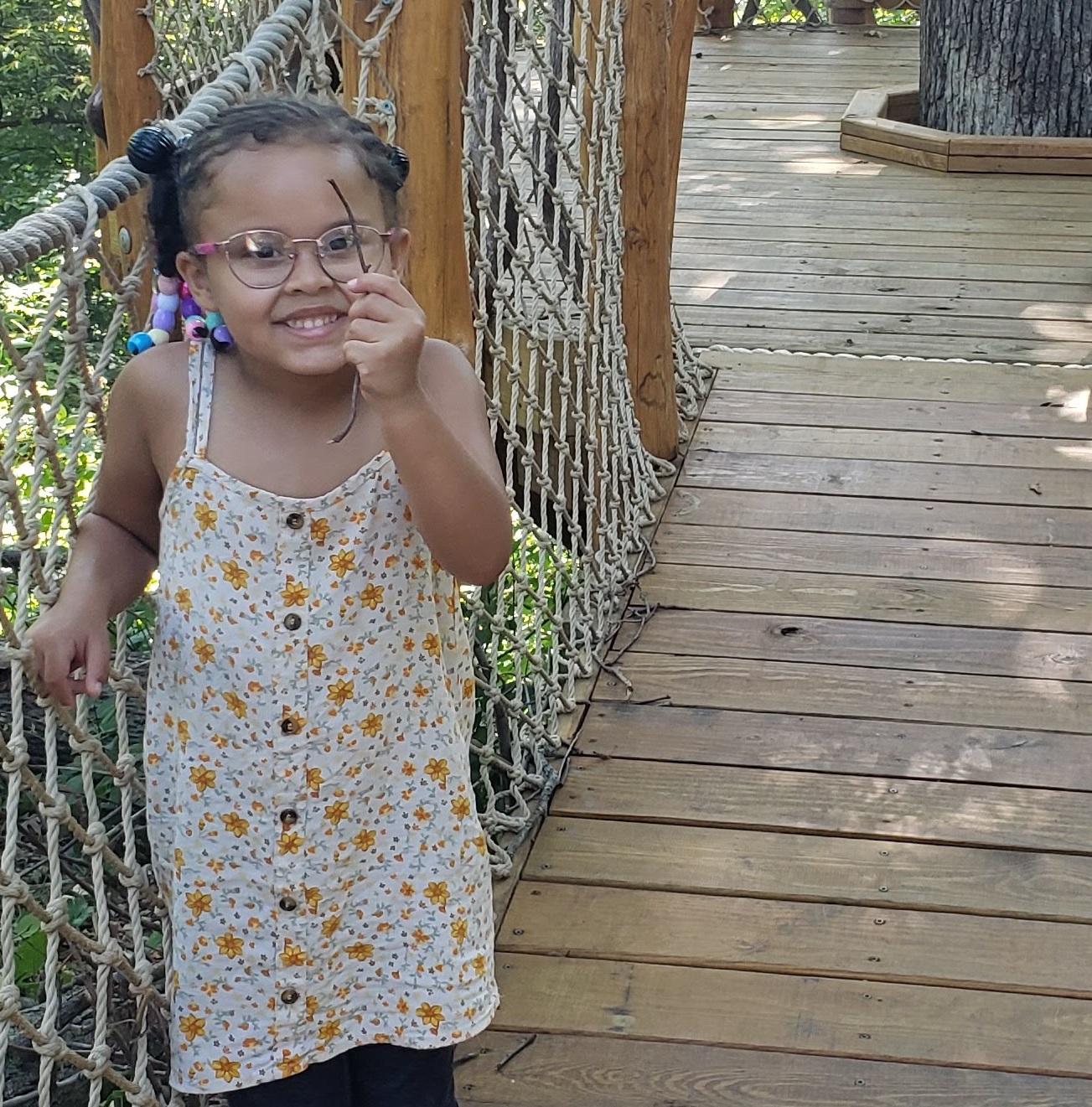 Girl discovers nature in a treehouse at Iowa Arboretum and Gardens