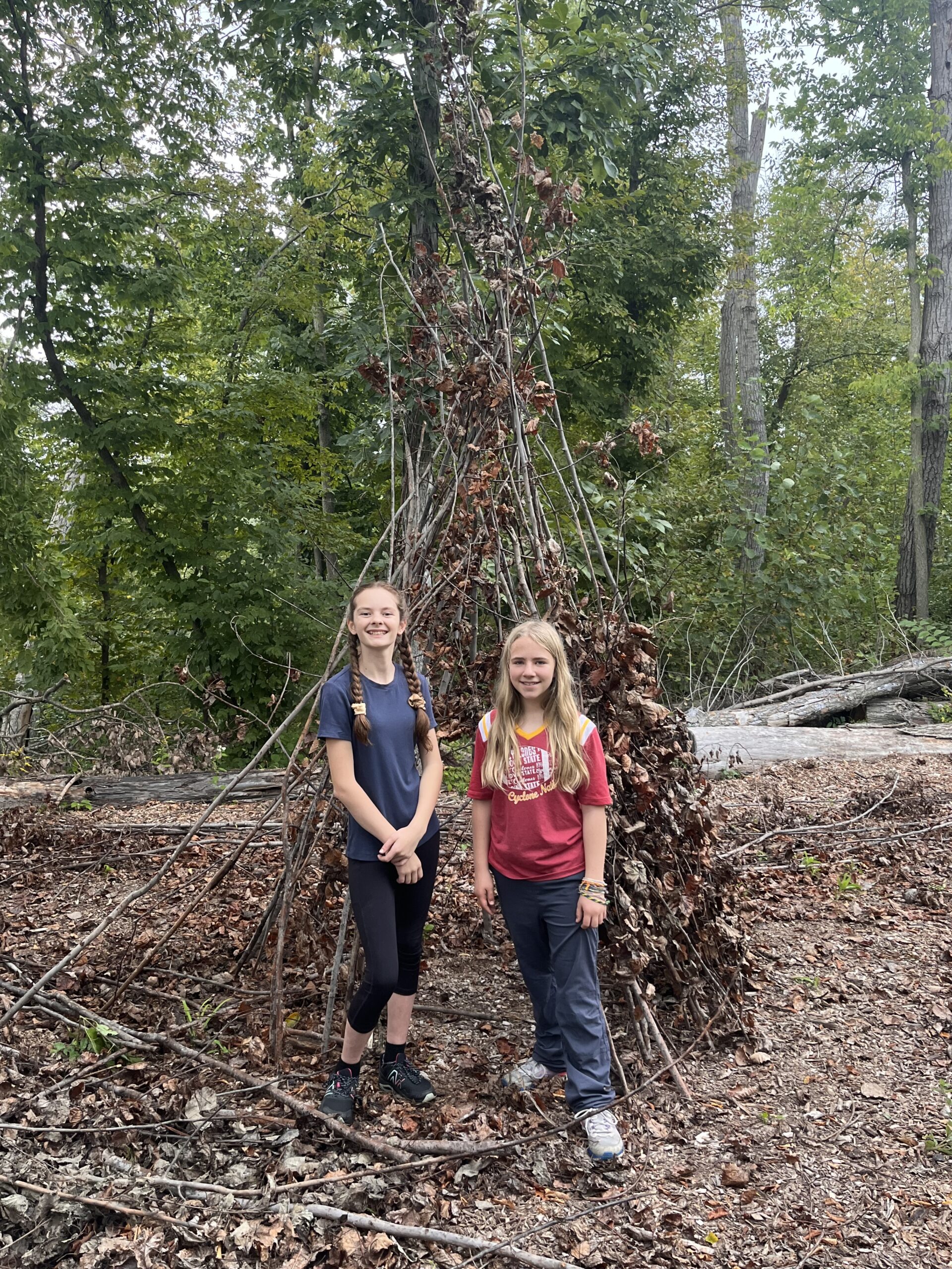 Girls with a constructed nature fort at Iowa Arboretum and Gardens